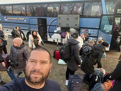 Refugees ready to ride to safety on a bus