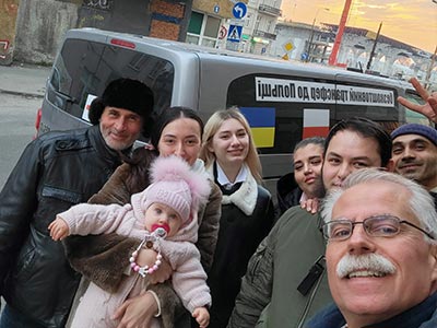 a family poses in front of a van